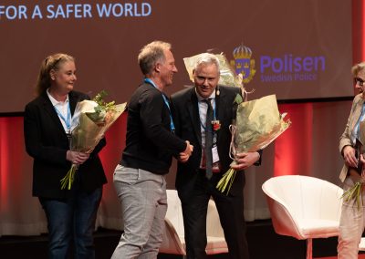 Dr. Simon Dunne receives flowers at the Closing Ceremony, Photo by Marcus Andrae.