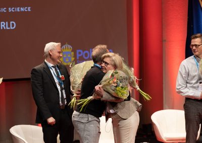 Dr. Simon Dunne receives flowers at the Closing Ceremony, Photo by Marcus Andrae.